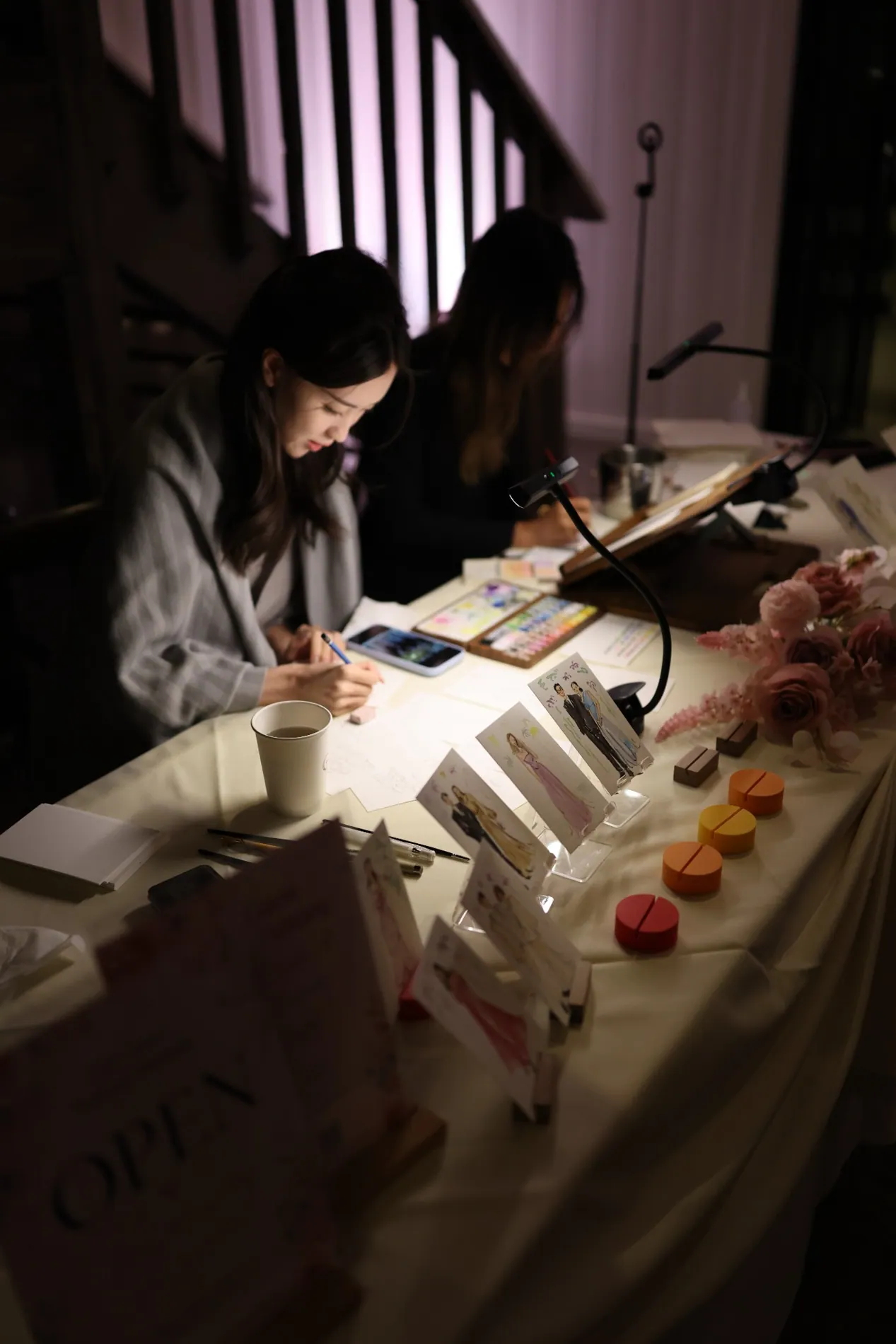 Hannah painting guest portraits during an event
